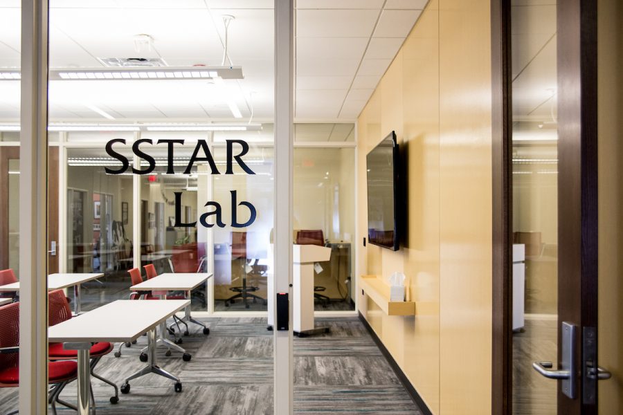 classroom behind glass that has text saying SSTAR Lab